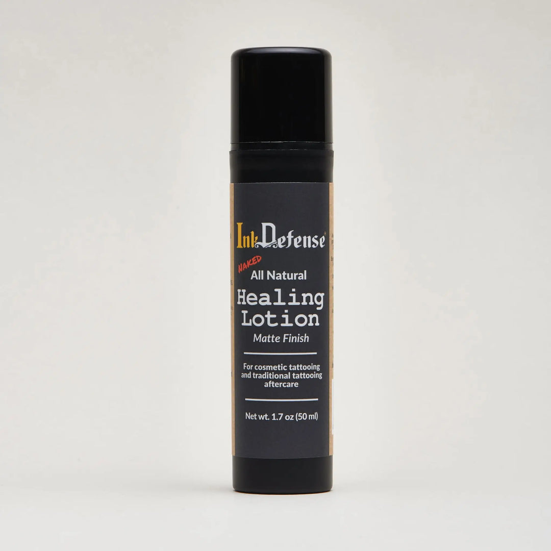 Black cylindrical bottle of ink defense all natural healing lotion with matte finish and gold accented label