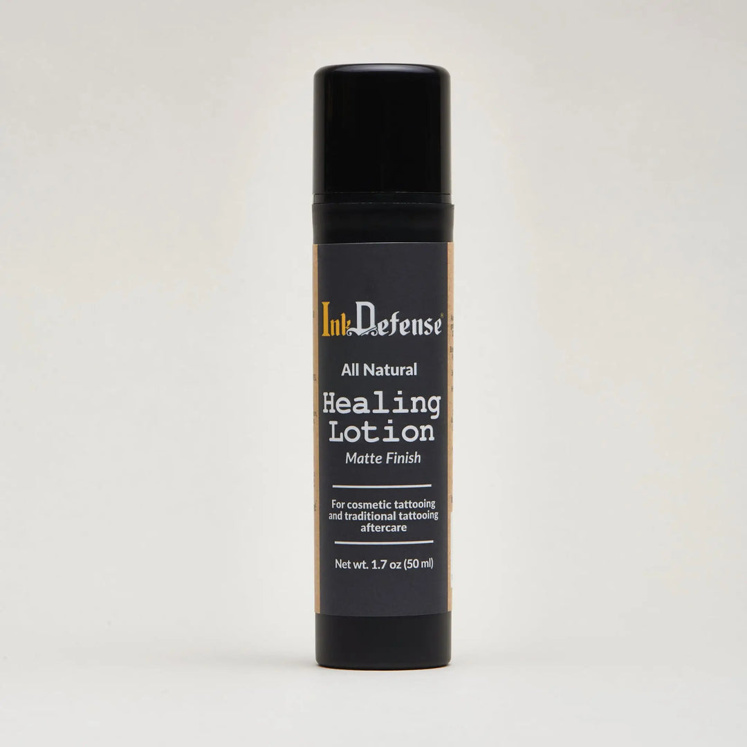 Black matte-finish spray bottle of ink defense all natural healing lotion for tattoo aftercare front side