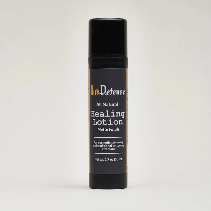 Black matte-finish spray bottle of ink defense all natural healing lotion for tattoo aftercare front side