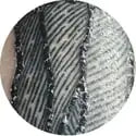Silver metallic circular object with a textured, ribbed surface.