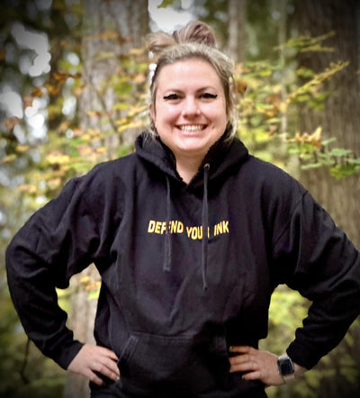 Woman wearing Defend Your Ink Hoodie from Ink Defense